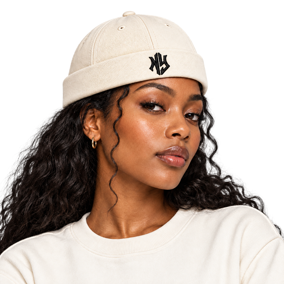 Female model wearing NY Brimless Hat in Cream