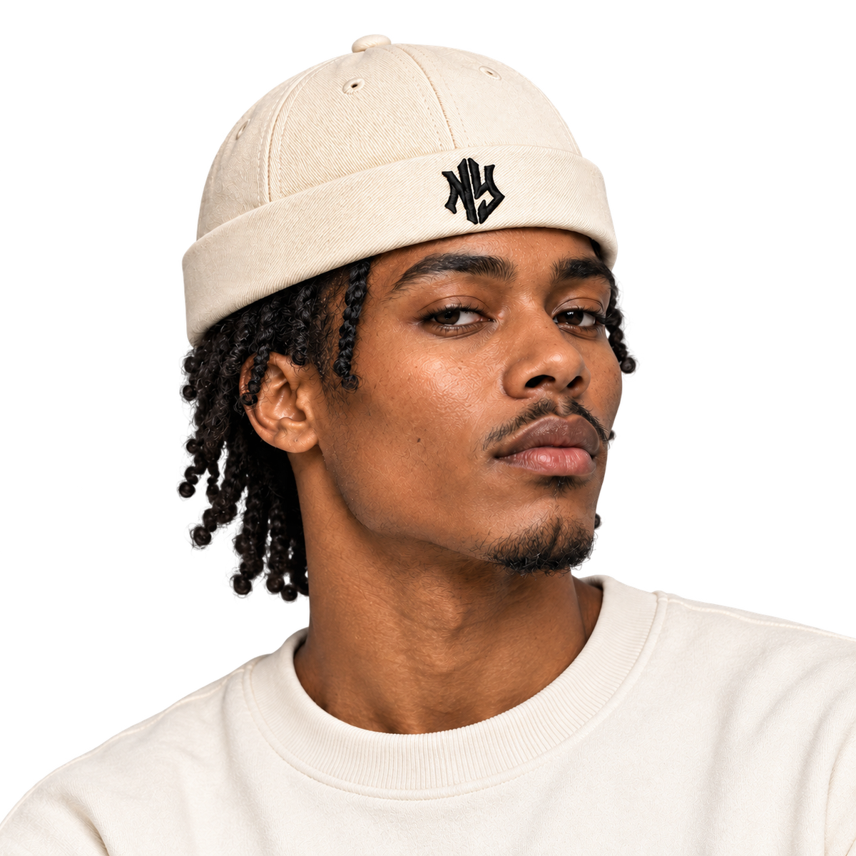 Male model wearing NY Brimless Hat in Cream