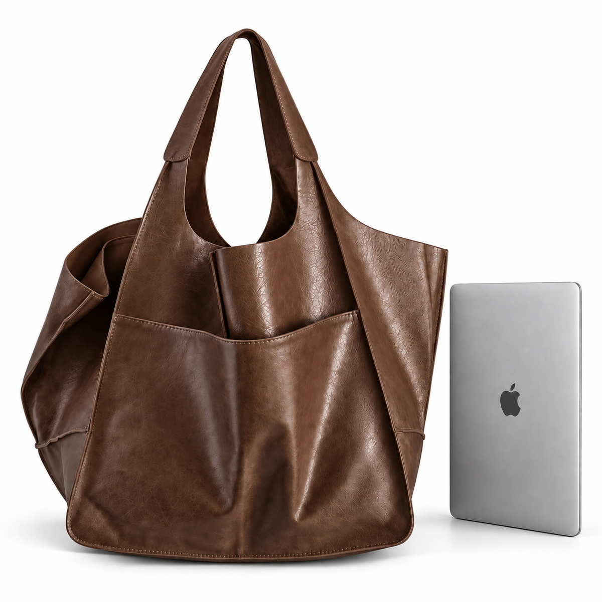 Oversized brown tote bag next to 13-inch MacBook for size comparison