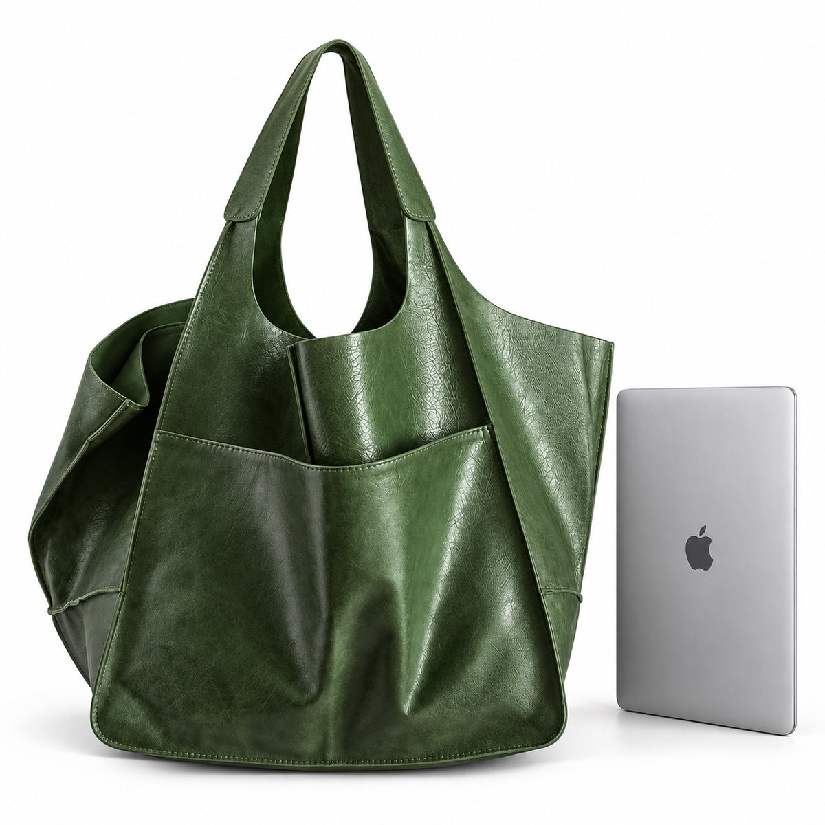 Oversized green tote bag next to 13-inch MacBook for size comparison