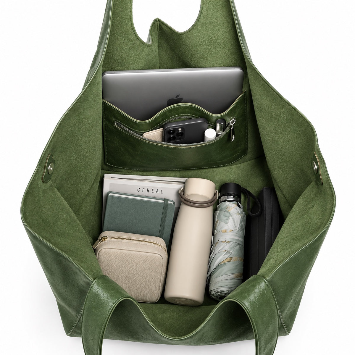 Oversized green tote bag filled with laptop and everyday essentials